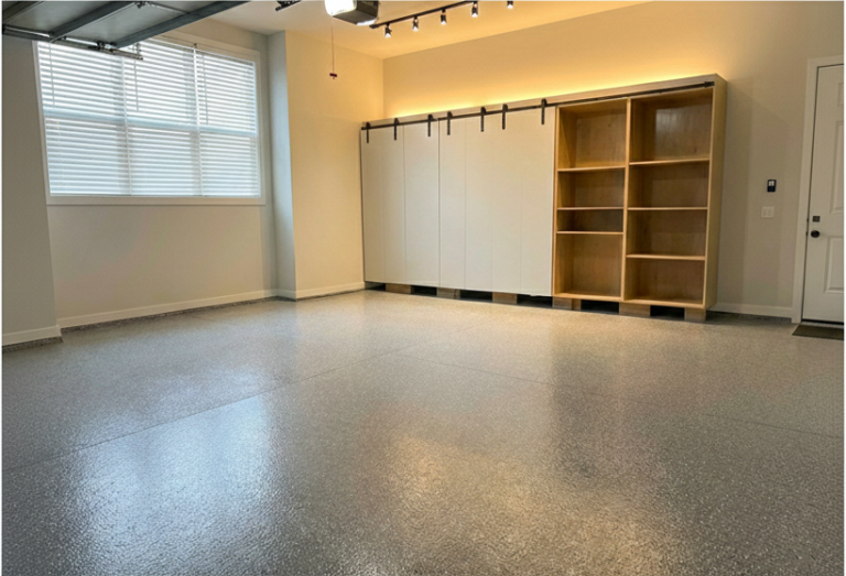 Finished residential garage with grey epoxy flake floor and custom cabinets installed by Ironside Epoxy
